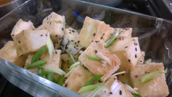 Tofu cubes with a light and crispy toasted sesame seed coating 