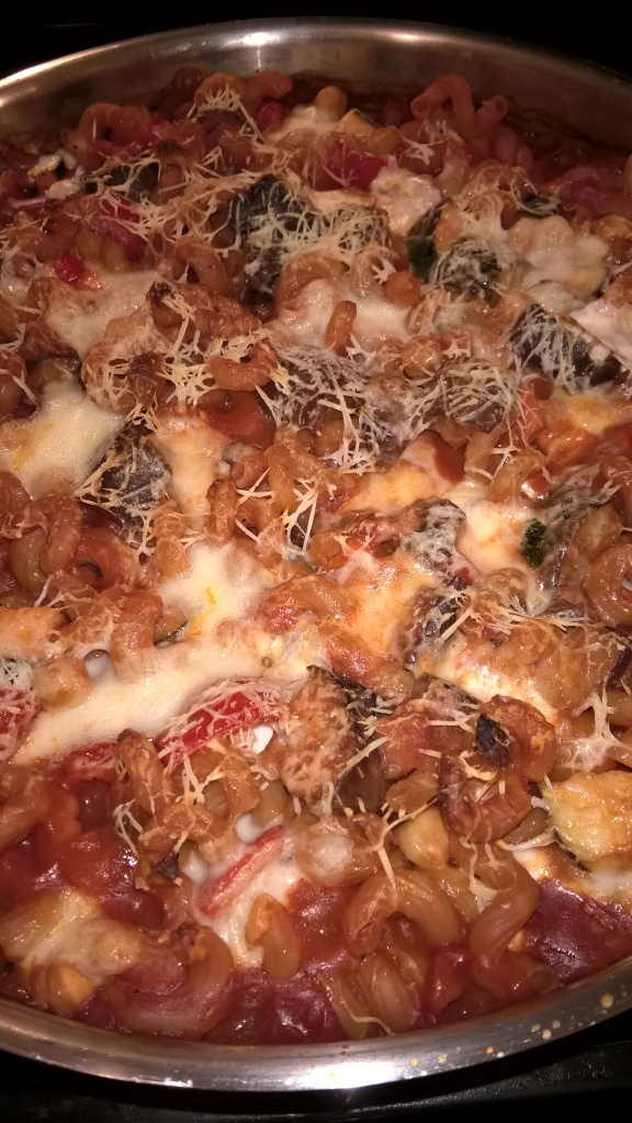 Cheesy topped baked pasta with eggplant, zucchini, peppers and tomatoes, yum!